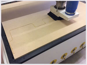 CNC router cutting section of wood